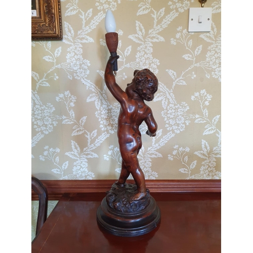 420 - A carved wood figure of a putto, on a turned base, 54 cm high (excluding fitment)