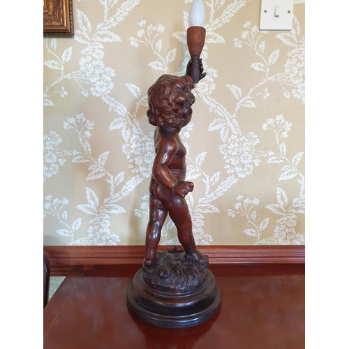 420 - A carved wood figure of a putto, on a turned base, 54 cm high (excluding fitment)