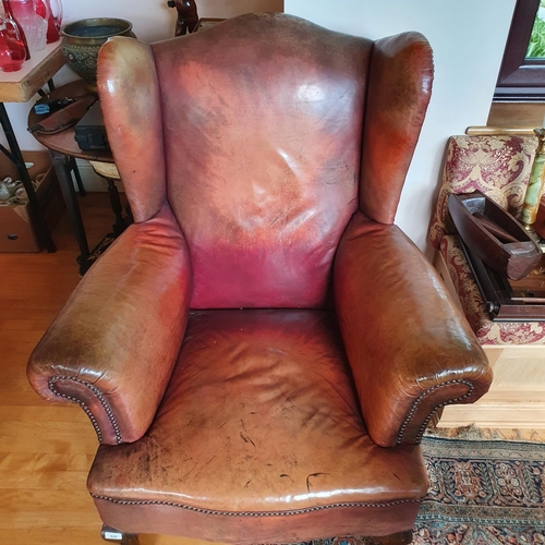 428 - A George III style wing armchair, upholstered in leather, on cabriole front legs, with claw and ball... 