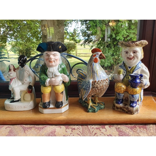 434 - A Continental toby jug, 25 cm high, a similar cockerel, another toby jug, and a Staffordshire group ... 