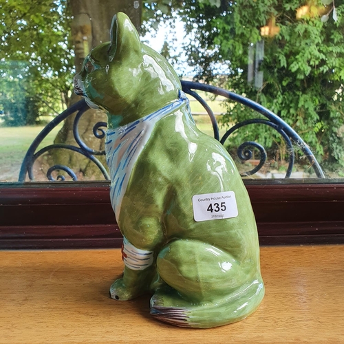 435 - A Mosanic pottery figure, of a seated cat, a front leg with a bandage, 25 cm high