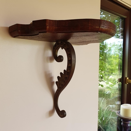 444 - A carved oak wall bracket, 40 cm wide, and another similar bracket, 31 cm wide (2)