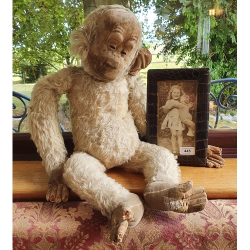 445 - A Merrythought plush monkey, approx. 60 cm high, having been well loved over the years, with a photo... 