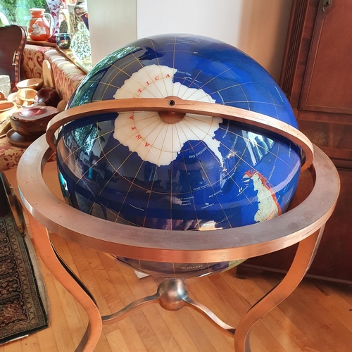 449 - A large library type modern globe, approx. 68 cm diameter, in a copper stand/frame, approx. 105 cm h... 