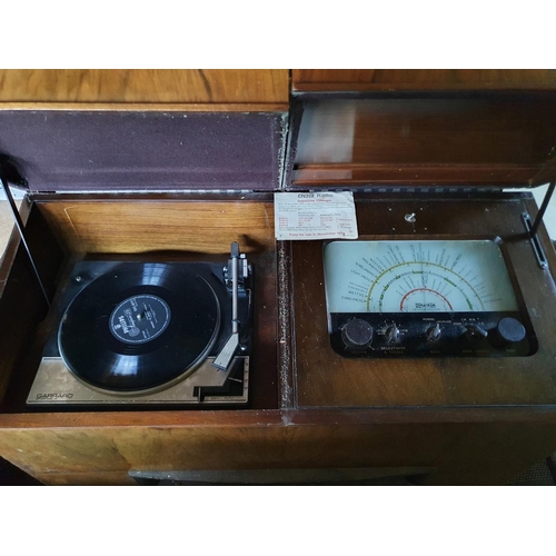 135 - A Dynatron radio, with a Garrard SP 25 MK IV record deck, in a walnut case, 89 cm wide