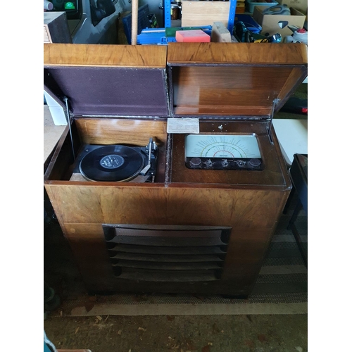 135 - A Dynatron radio, with a Garrard SP 25 MK IV record deck, in a walnut case, 89 cm wide