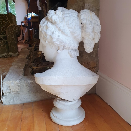 477 - A late 19th/early 20th century carved marble bust, of a lady with her hair tied up, on a socle base,... 