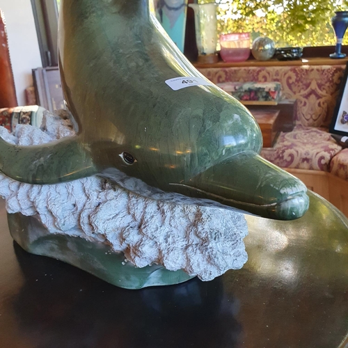 491 - A green resin figure, of a dolphin, 56 cm high