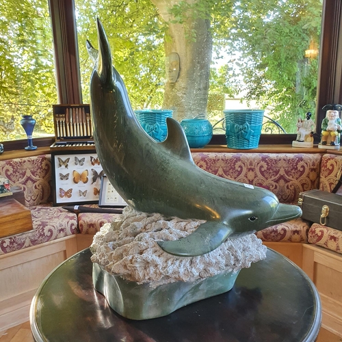 491 - A green resin figure, of a dolphin, 56 cm high