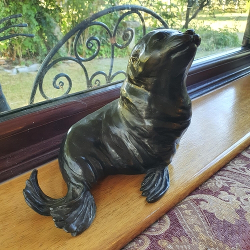 498 - A Rosalie Johnson bronze figure of a sealion, 19 cm high