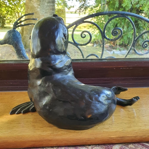 498 - A Rosalie Johnson bronze figure of a sealion, 19 cm high