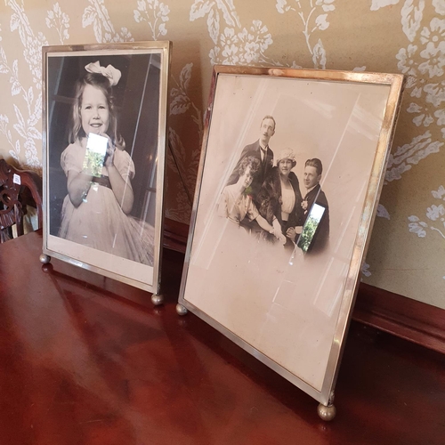 504 - A large pair of silver plated strut photograph frames, on ball front feet, 37 x 27 cm wide, a Victor... 