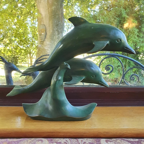 505 - A patinated bronze group, of two dolphins, slight loss, 30 cm high