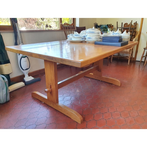 543 - A pine kitchen table, and end supports joined by a stretcher,  167 cm wide x 114 cm deep x 74 cm hig... 