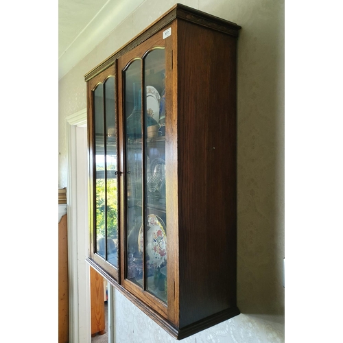 577 - A walnut bedside cupboard, 70 cm wide, and an oak hanging wall cupboard, 76 cm wide (2)