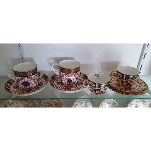 584 - A pair of Royal Crown Derby cups and saucers, and a similar pair of Derby cups and saucers (4)