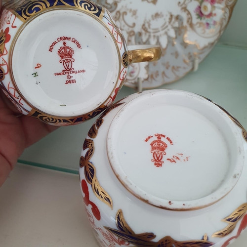 584 - A pair of Royal Crown Derby cups and saucers, and a similar pair of Derby cups and saucers (4)