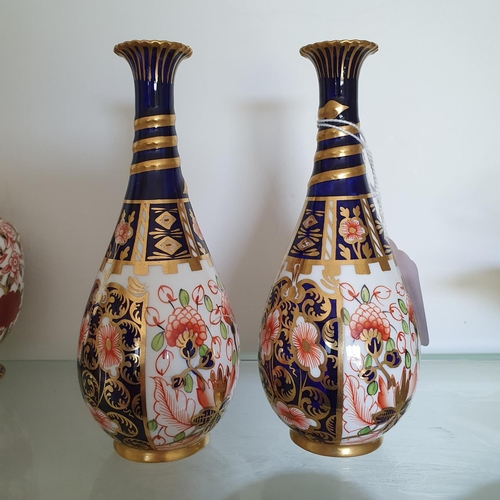 587 - A pair of Royal Crown Derby vases, of ovoid form, 15.5 cm high (2)