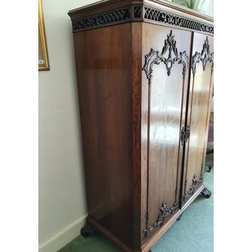 592 - An 18th century style mahogany wardrobe, having a pair of doors with rococo style decoration, of lea... 