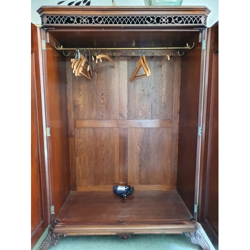 592 - An 18th century style mahogany wardrobe, having a pair of doors with rococo style decoration, of lea... 