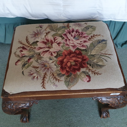 596 - An 18th century style carved walnut stool, on cabriole legs with claw and ball feet, 58 cm wide