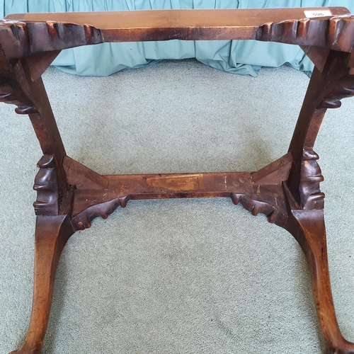 596 - An 18th century style carved walnut stool, on cabriole legs with claw and ball feet, 58 cm wide