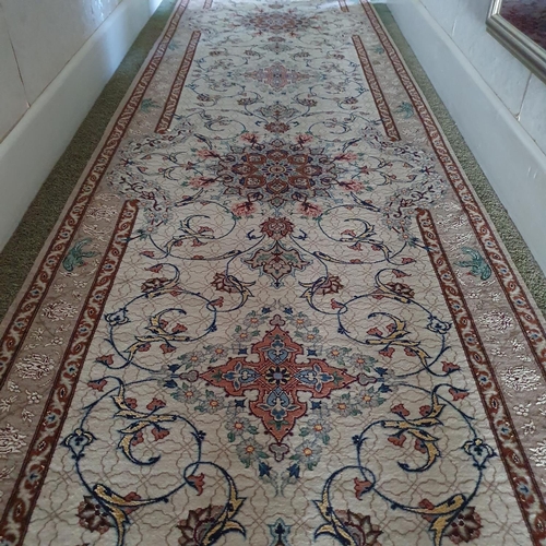 616 - A Persian runner, decorated foliage on a cream ground, 330 x 75 cm