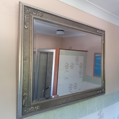 618 - The Second Bathroom.
The contents including assorted glass, a wall mirror in a silvered frame and su... 