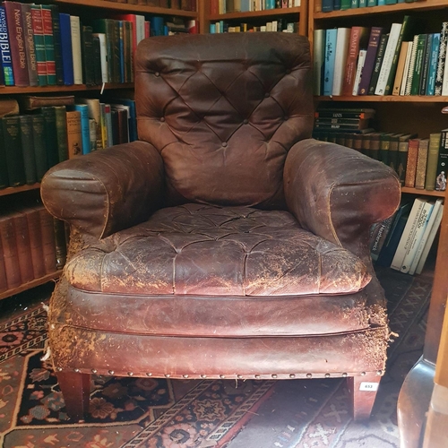 653 - The Attic. 
A leather upholstered country house armchair, in need of repair, some buttons missing fr... 