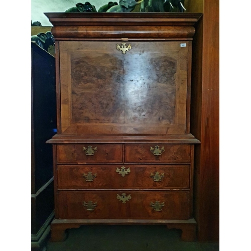 658 - An 18th century escritoire, veneered in walnut, having a frieze drawer above a fall front revealing ... 