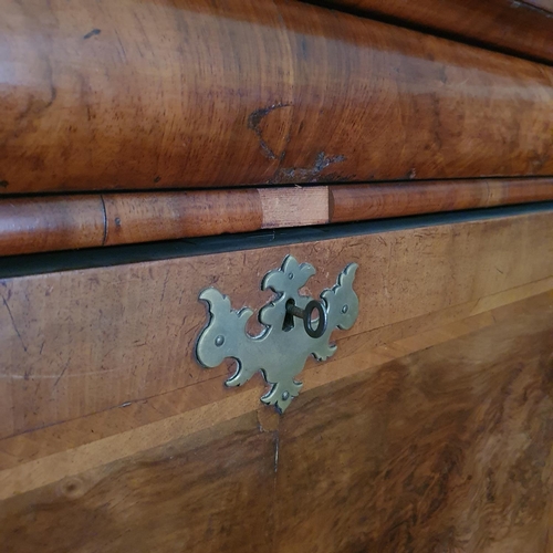 658 - An 18th century escritoire, veneered in walnut, having a frieze drawer above a fall front revealing ... 