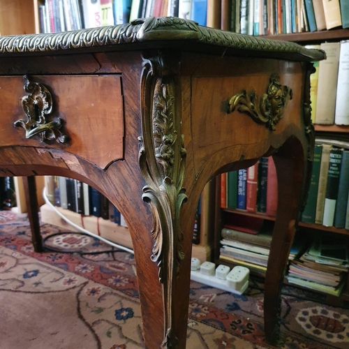 659 - A Louis XVI style writing desk, of shaped outline, the leather inset top above three frieze drawers,... 