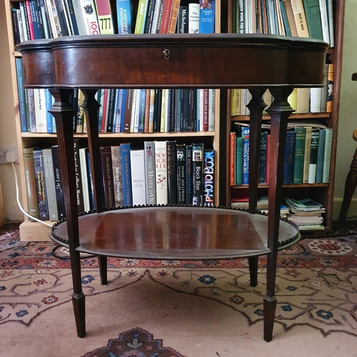 660 - An Edwardian mahogany table vitrine, of lobed oval form, on tapering reeded legs joined by an undert... 