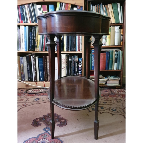 660 - An Edwardian mahogany table vitrine, of lobed oval form, on tapering reeded legs joined by an undert... 