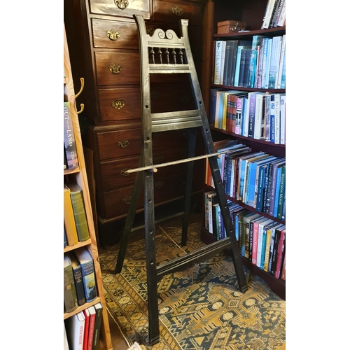 668 - A late Victorian ebonised easel, 154 cm wide