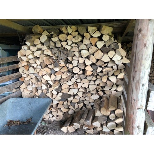 33 - A large quantity of seasoned logs, in both bays of the open barn...