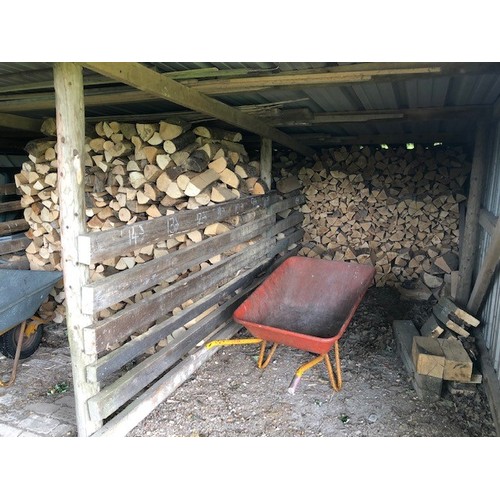 33 - A large quantity of seasoned logs, in both bays of the open barn...