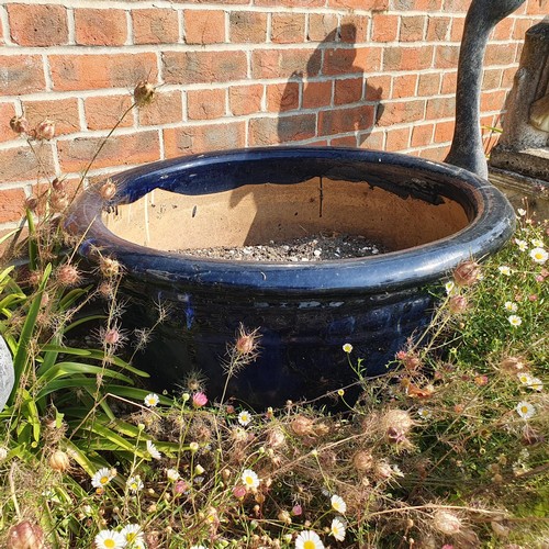 82 - A large blue glazed garden pot, approx. 36 cm high, and a pair of silver painted geese ornaments (3)