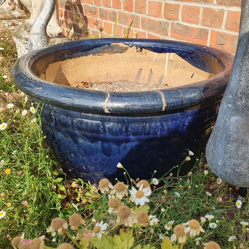 82 - A large blue glazed garden pot, approx. 36 cm high, and a pair of silver painted geese ornaments (3)