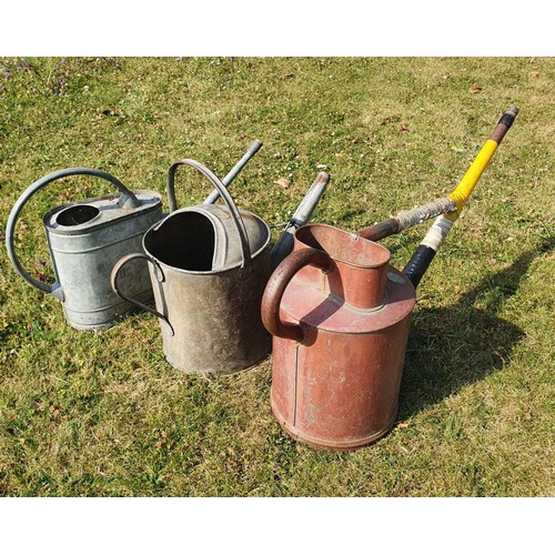 83 - A galvanised metal two gallon watering can, and two others similar (3)