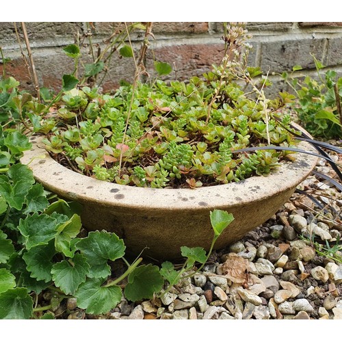 65 - A pair of green glazed pineapple type finials, 48 cm high, and the group of planters on the gravel i... 