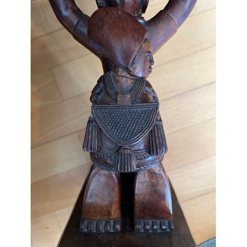 221 - An African low table, on a carved figural support, 45 cm high