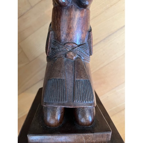 221 - An African low table, on a carved figural support, 45 cm high