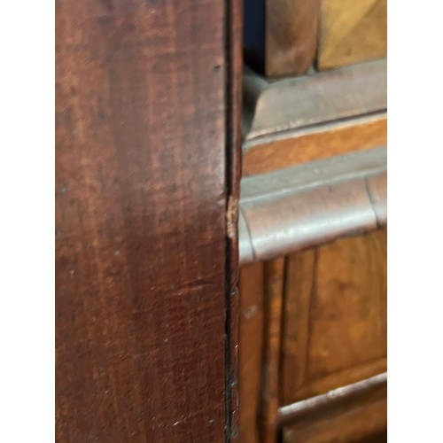 657 - A George III mahogany linen press, having a pair of panel doors enclosing sliding trays, above two s... 