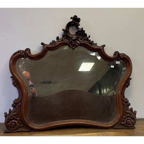 872 - A carved walnut framed mirror, 140 x 82 cm