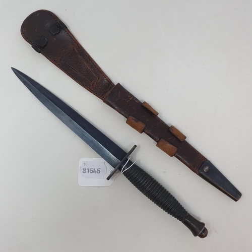 30 - A Fairbairn and Sykes Commando  knife, in leather sheath, 32 cm