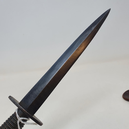 30 - A Fairbairn and Sykes Commando  knife, in leather sheath, 32 cm