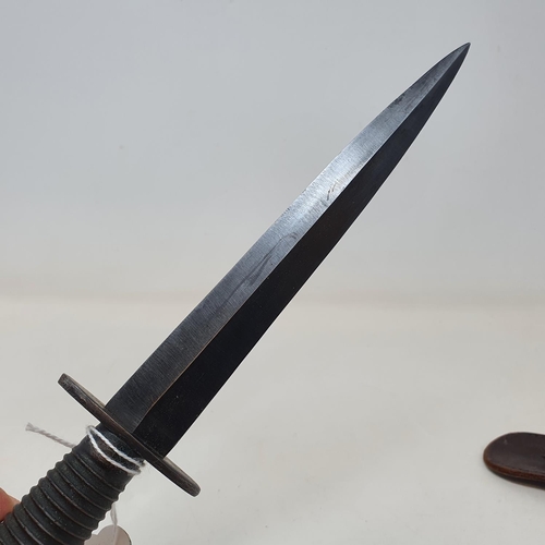 30 - A Fairbairn and Sykes Commando  knife, in leather sheath, 32 cm