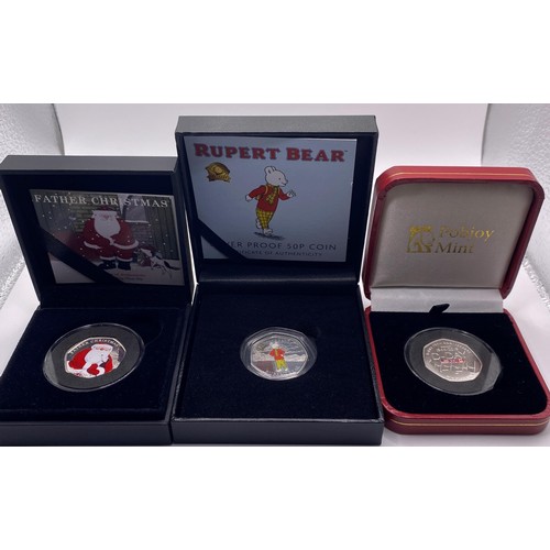 198 - A silver proof Rupert Bear 50p piece, three other commemorative coins, and a VE medal set