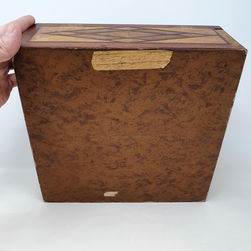 566 - A marquetry inlaid box, 27 cm wide, and a rattle, 31 cm (2)